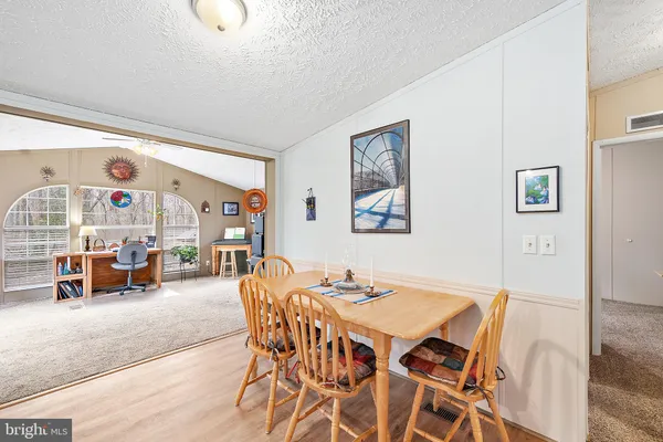 a dining room with furniture and wooden floor