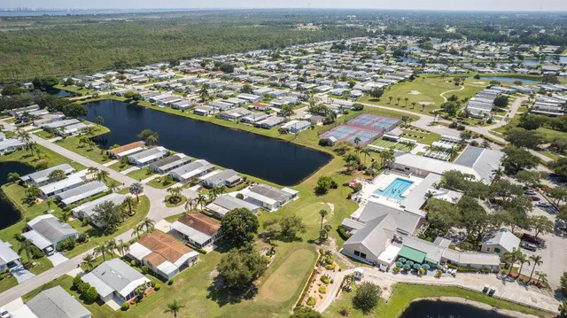 an aerial view of a house with a yard and lake view