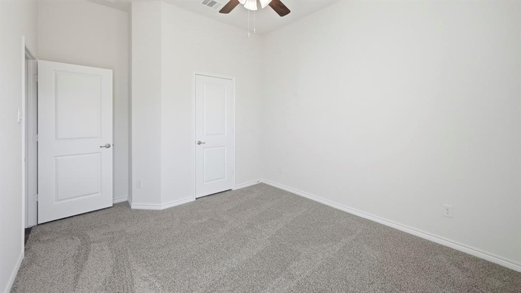 4163 Waldron Trail Forney, TX 75126 - Photo 22 of 30 Room featuring light gray carpeting, crisp white walls, and a ceiling fan with wood-finish blades