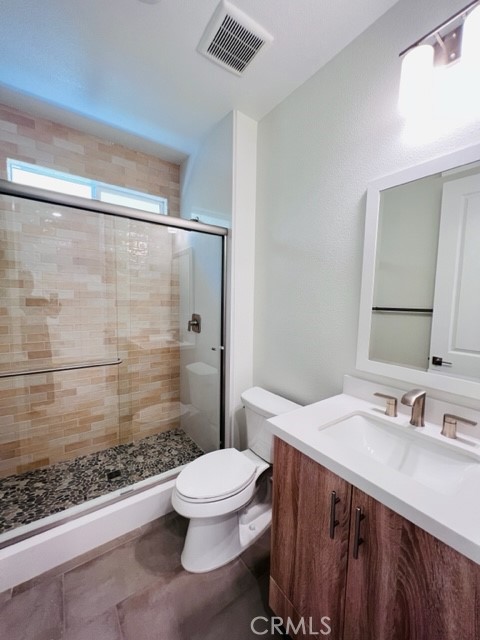27613 Skylily Way San Pedro, CA 90732 - Photo 14 of 27 a bathroom with a sink a toilet a mirror and shower