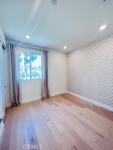 27613 Skylily Way San Pedro, CA 90732 - Photo 19 of 27 an empty room with wooden floor and windows