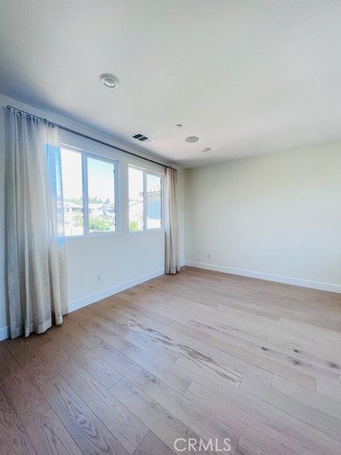 27613 Skylily Way San Pedro, CA 90732 - Photo 21 of 27 an empty room with wooden floor and windows