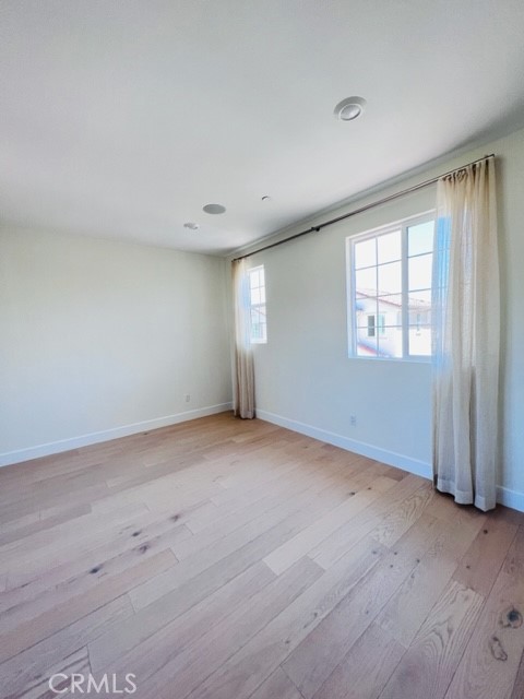 27613 Skylily Way San Pedro, CA 90732 - Photo 22 of 27 an empty room with wooden floor and windows