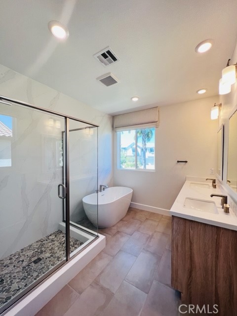 27613 Skylily Way San Pedro, CA 90732 - Photo 23 of 27 a bathroom with a granite countertop sink a toilet a mirror and shower