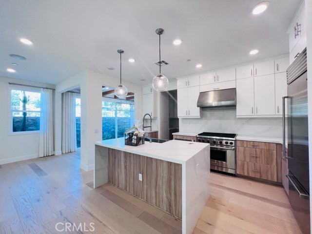 27613 Skylily Way San Pedro, CA 90732 - Photo 9 of 27 a kitchen with stainless steel appliances granite countertop a sink stove and refrigerator