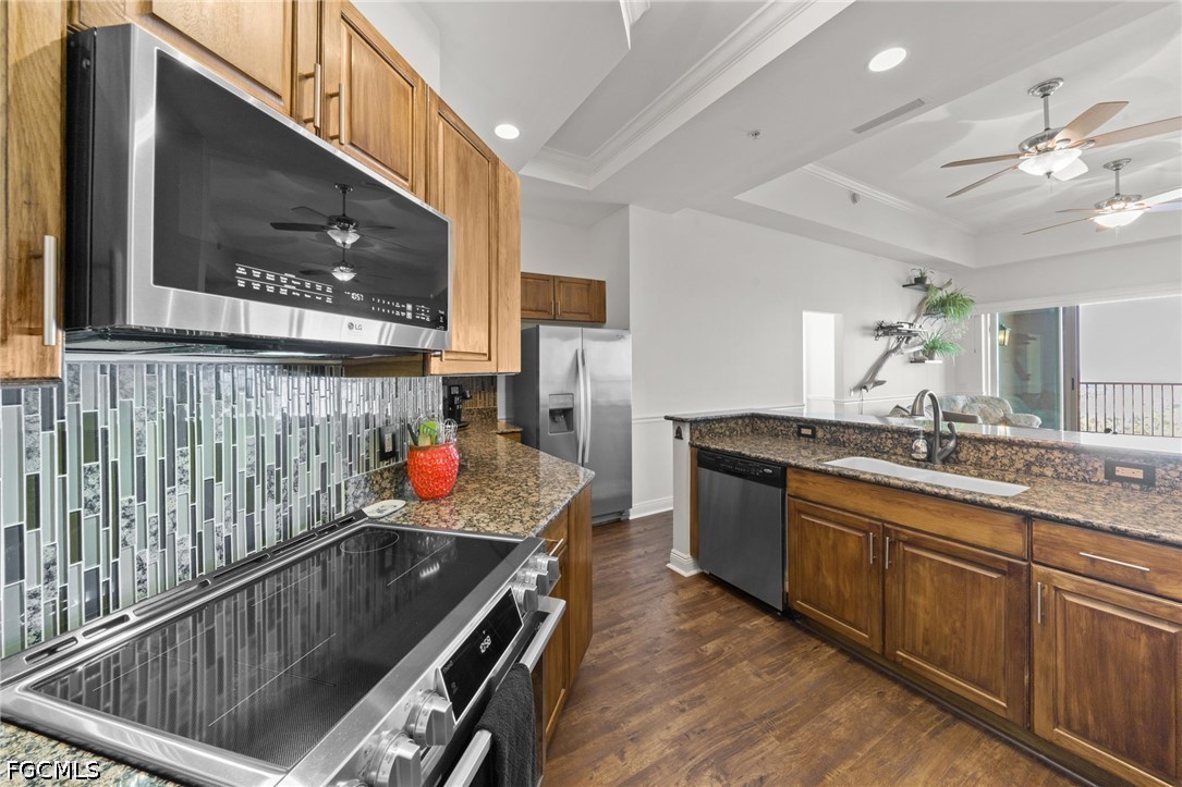 2743 First Street, Unit 2703 Fort Myers, FL 33916 - Photo 11 of 50 a kitchen with stainless steel appliances granite countertop a sink and cabinets