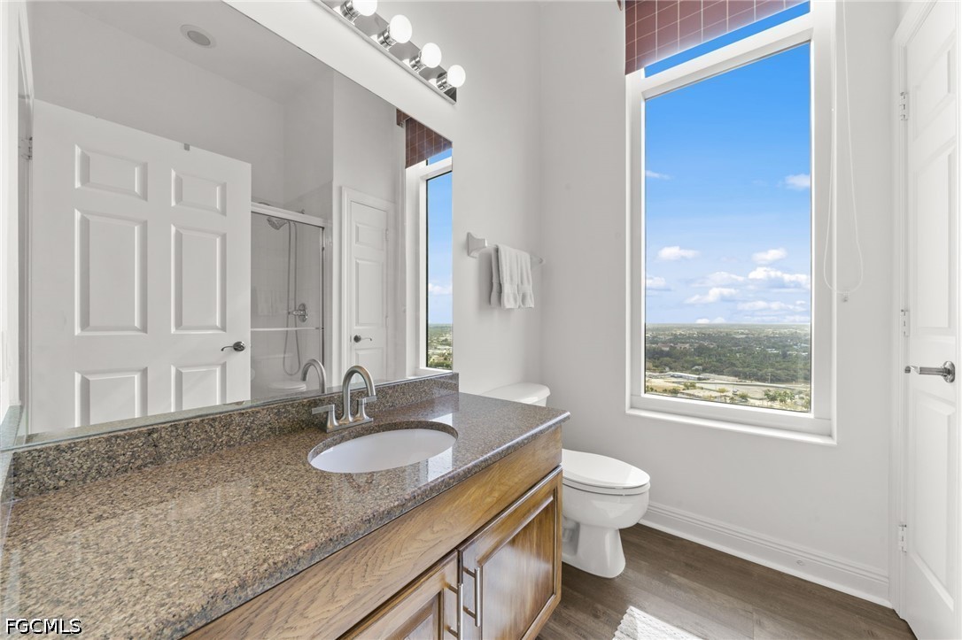 2743 First Street, Unit 2703 Fort Myers, FL 33916 - Photo 24 of 50 a bathroom with a granite countertop sink toilet and mirror