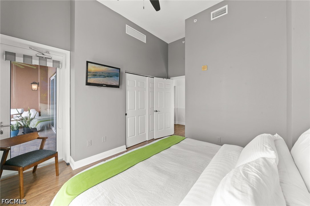 2743 First Street, Unit 2703 Fort Myers, FL 33916 - Photo 26 of 50 a bedroom with a bed and a chair