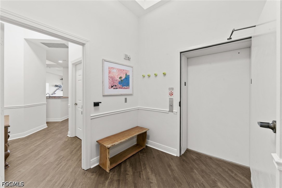 2743 First Street, Unit 2703 Fort Myers, FL 33916 - Photo 5 of 50 a hallway with wooden floor and furniture