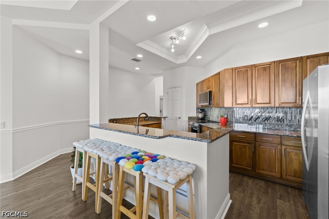 2743 First Street, Unit 2703 Fort Myers, FL 33916 - Photo 9 of 50 a kitchen that has a lot of cabinets in it and wooden floors