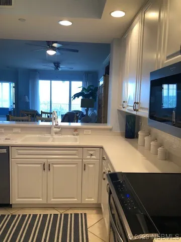 a kitchen with a sink and a stove top oven