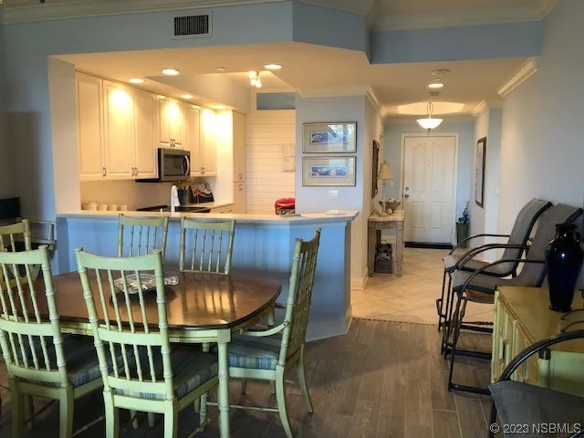 a dining room with furniture and wooden floor