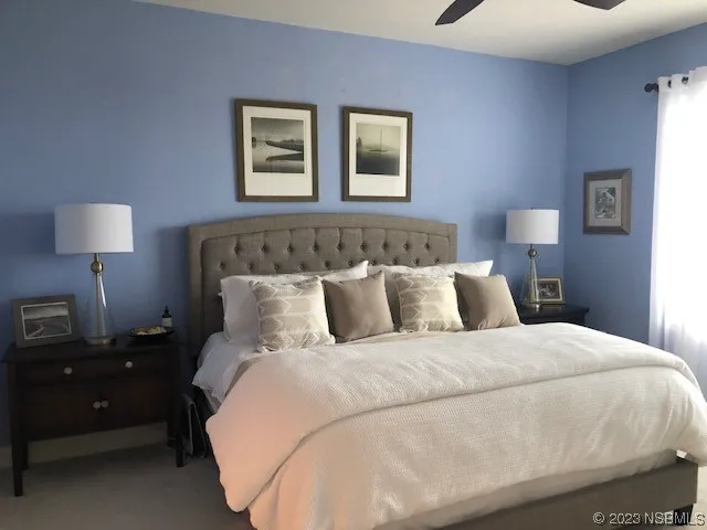 a bedroom with a bed and a lamp
