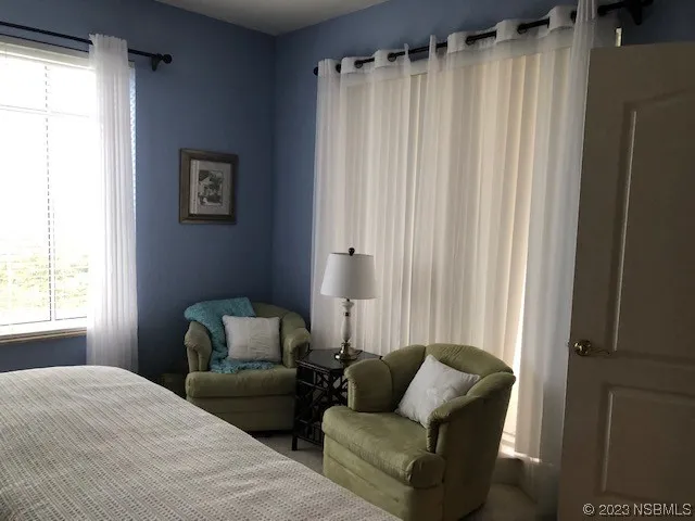 a bedroom with furniture and a window