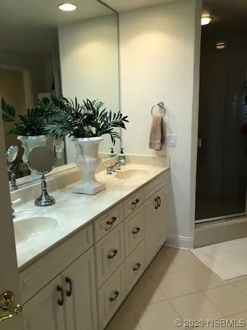 a bathroom with a double vanity sink and a mirror