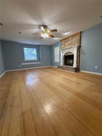 a kitchen with granite countertop a sink a stove top oven and cabinetry