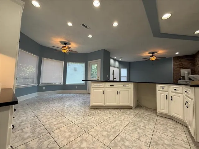 a view of a kitchen with a sink and cabinets