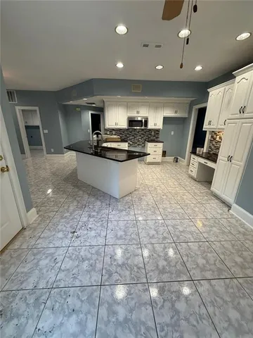 a kitchen with stainless steel appliances a sink a stove a microwave and cabinets