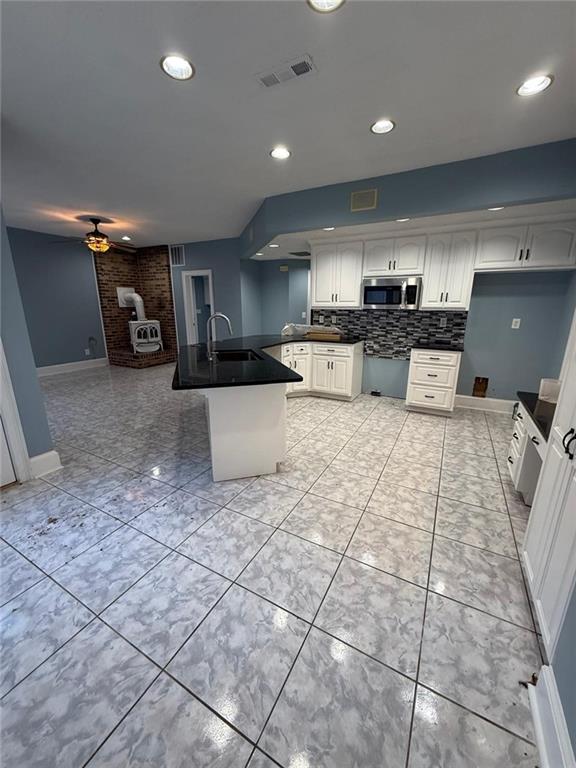 2337 Hollonville Road Brooks, GA 30205 - Photo 20 of 50 a kitchen with stainless steel appliances a sink a stove a microwave and cabinets