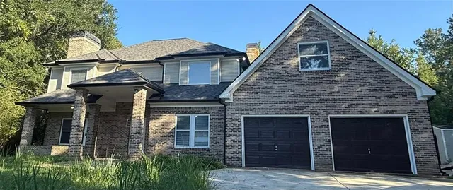 front view of a house with a small yard