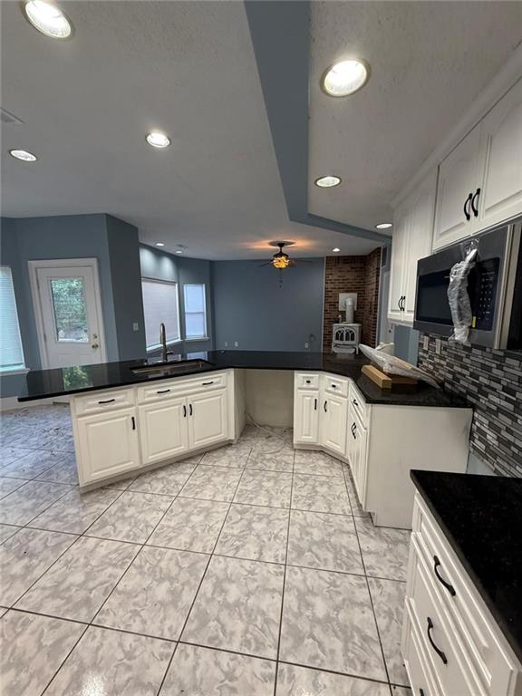 2337 Hollonville Road Brooks, GA 30205 - Photo 26 of 50 a large white kitchen with stainless steel appliances kitchen island granite countertop a stove a sink a microwave and a refrigerator