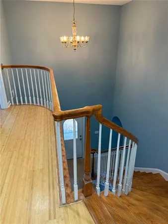 a view of a bedroom with wooden floor
