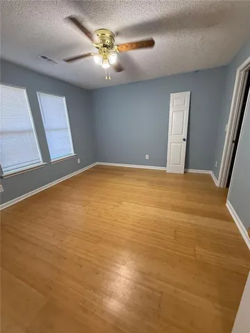 a bathroom with a granite countertop sink a mirror and shower
