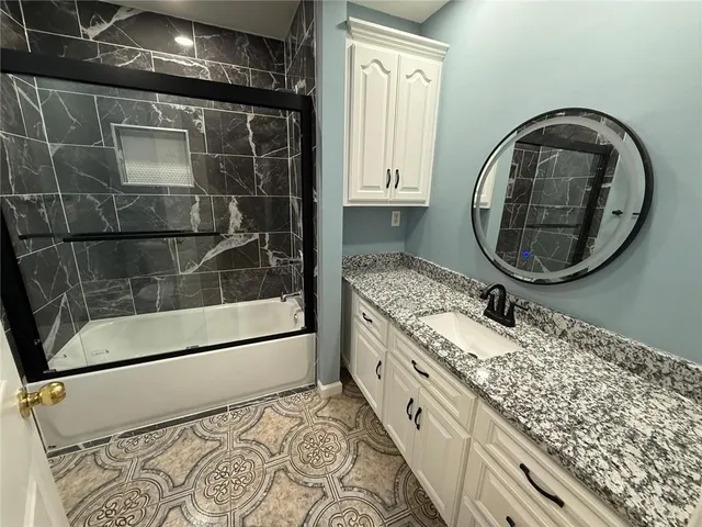 a bathroom with a double vanity sink and a mirror