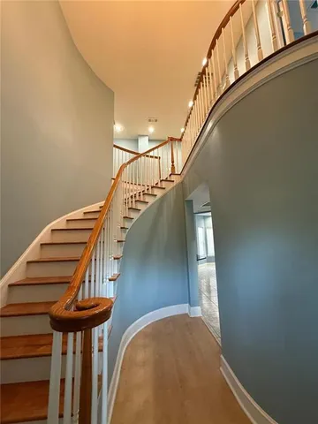 a view of entryway and hall with wooden floor