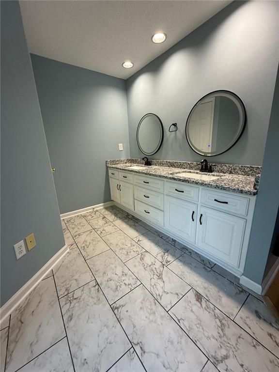 2337 Hollonville Road Brooks, GA 30205 - Photo 42 of 50 a bathroom with a double vanity sink and a mirror