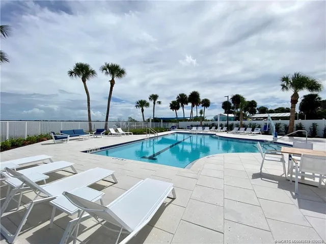 a view of a swimming pool with outdoor seating