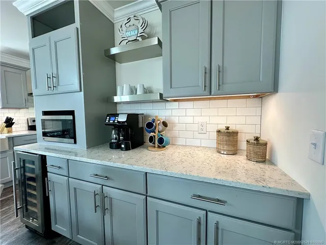 a kitchen with sink cabinets and microwave