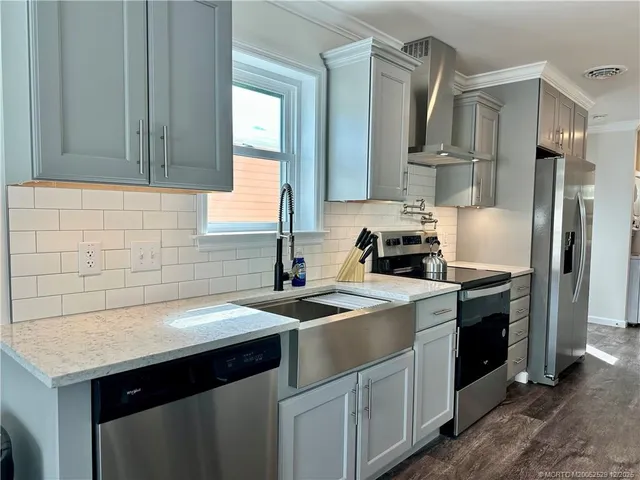 a kitchen with a sink and a stove