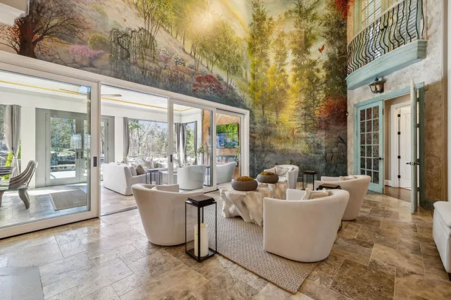 a living room with furniture and a chandelier