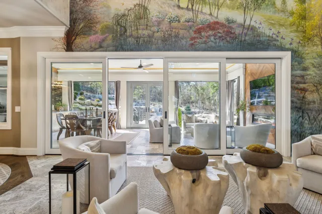 a dining room with furniture a chandelier and window
