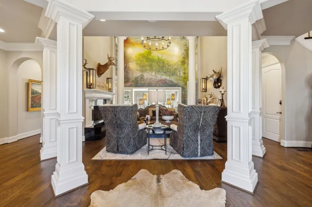 a living room with couches and a dining table with garden view