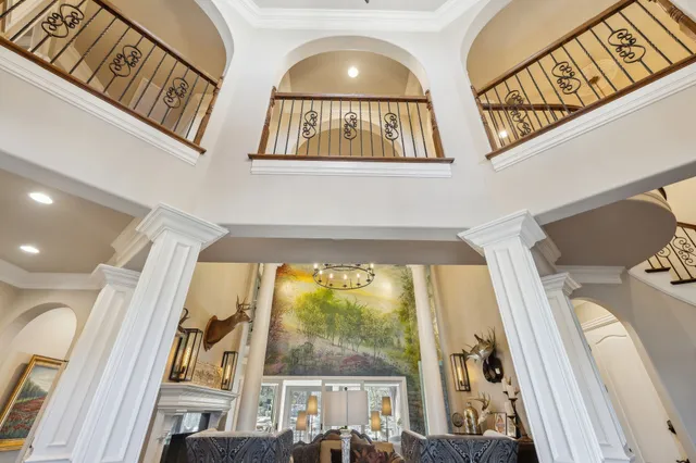 a dining room with furniture a chandelier and wooden floor