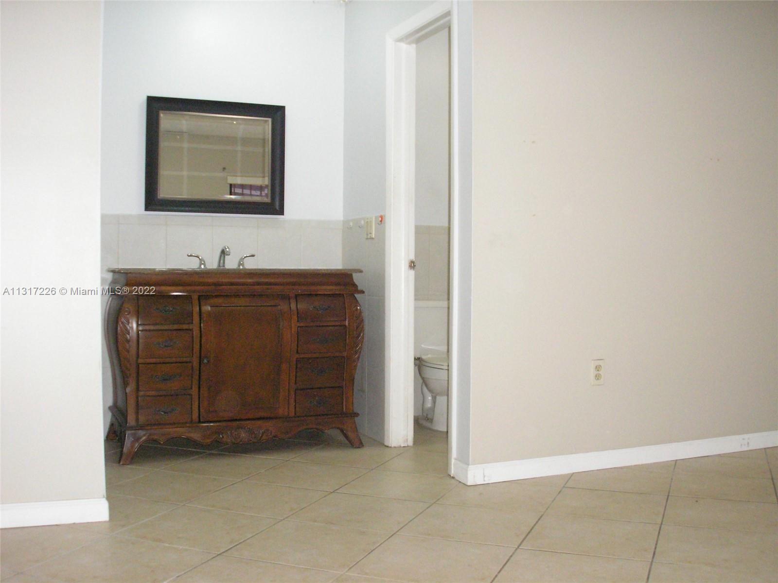 Fountainebleau Miami, FL 33174 - Photo 11 of 16 a bathroom with a sink and a mirror