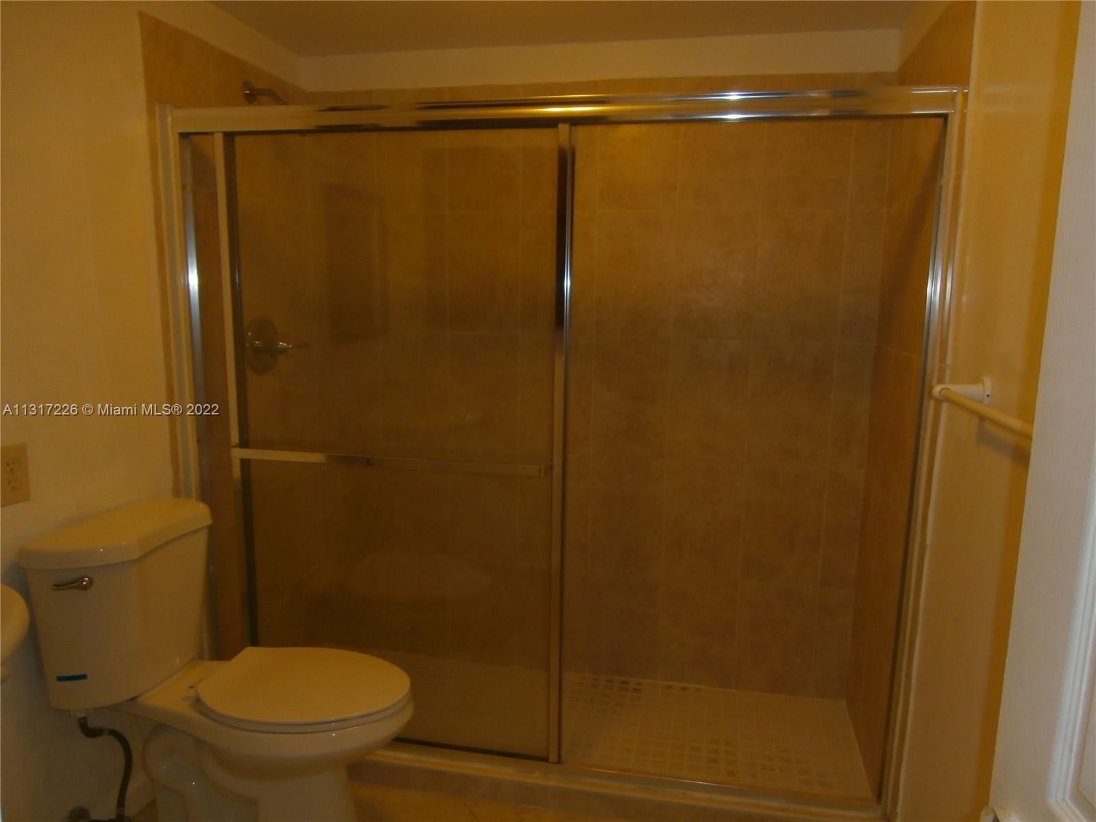 Fountainebleau Miami, FL 33174 - Photo 14 of 16 a bathroom with a shower and a toilet