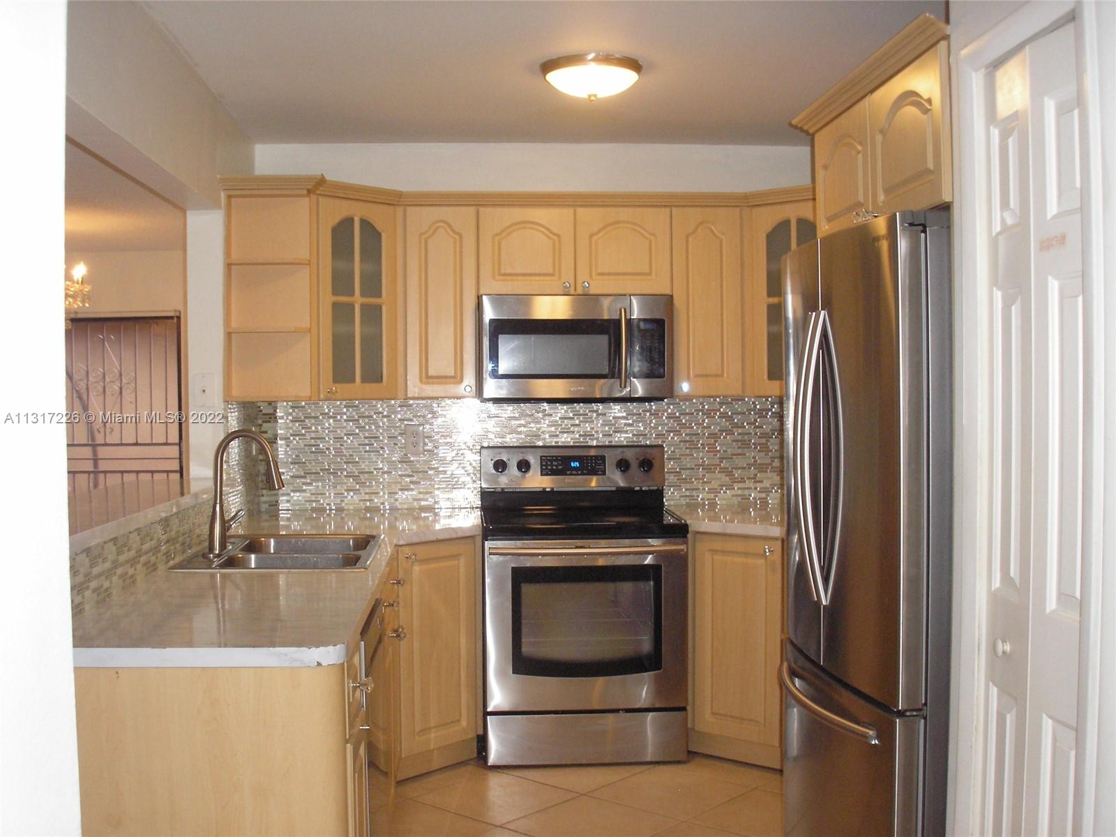 Fountainebleau Miami, FL 33174 - Photo 3 of 16 a kitchen with a refrigerator sink and microwave