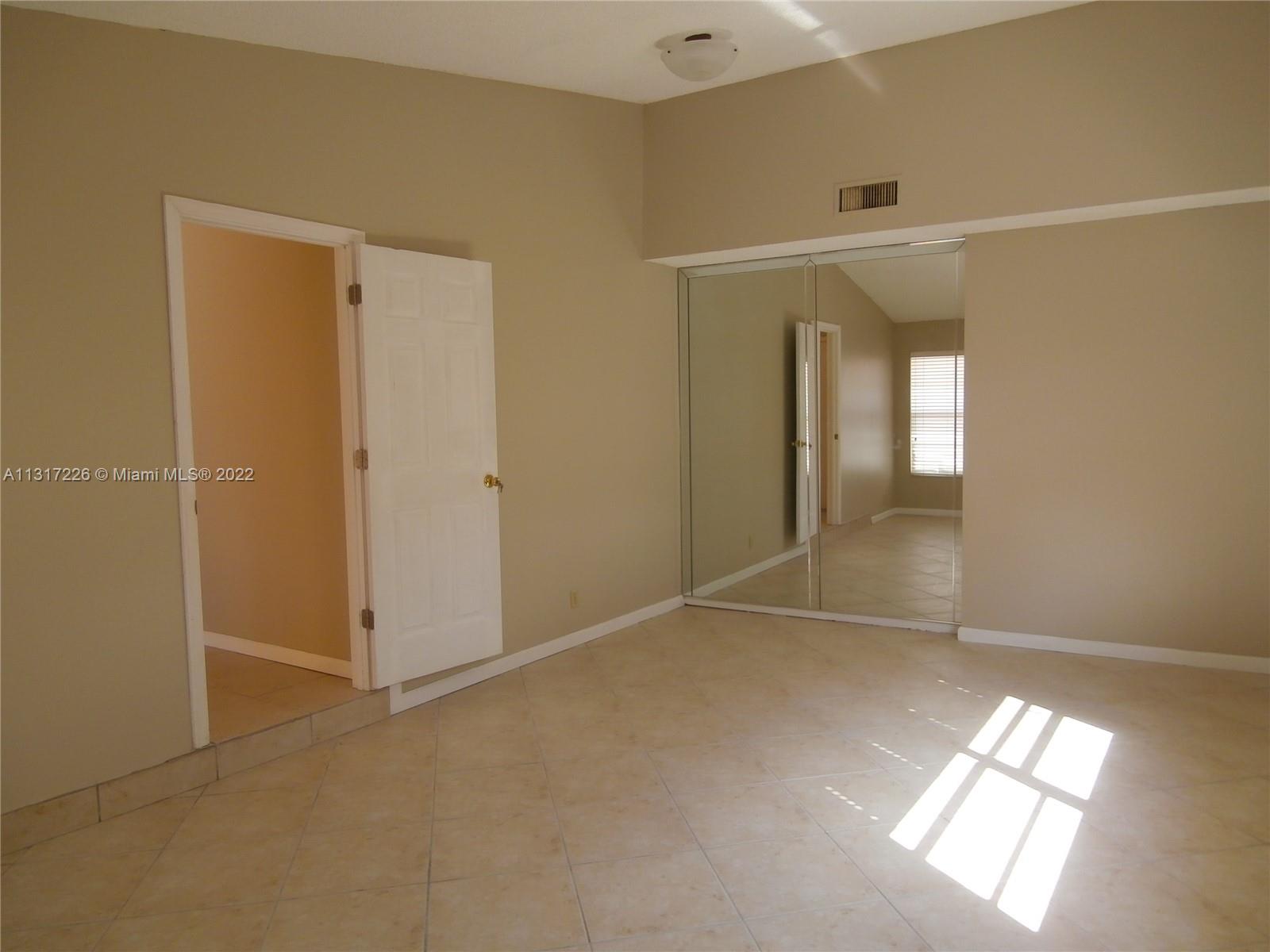 Fountainebleau Miami, FL 33174 - Photo 5 of 16 an empty room with windows and closet