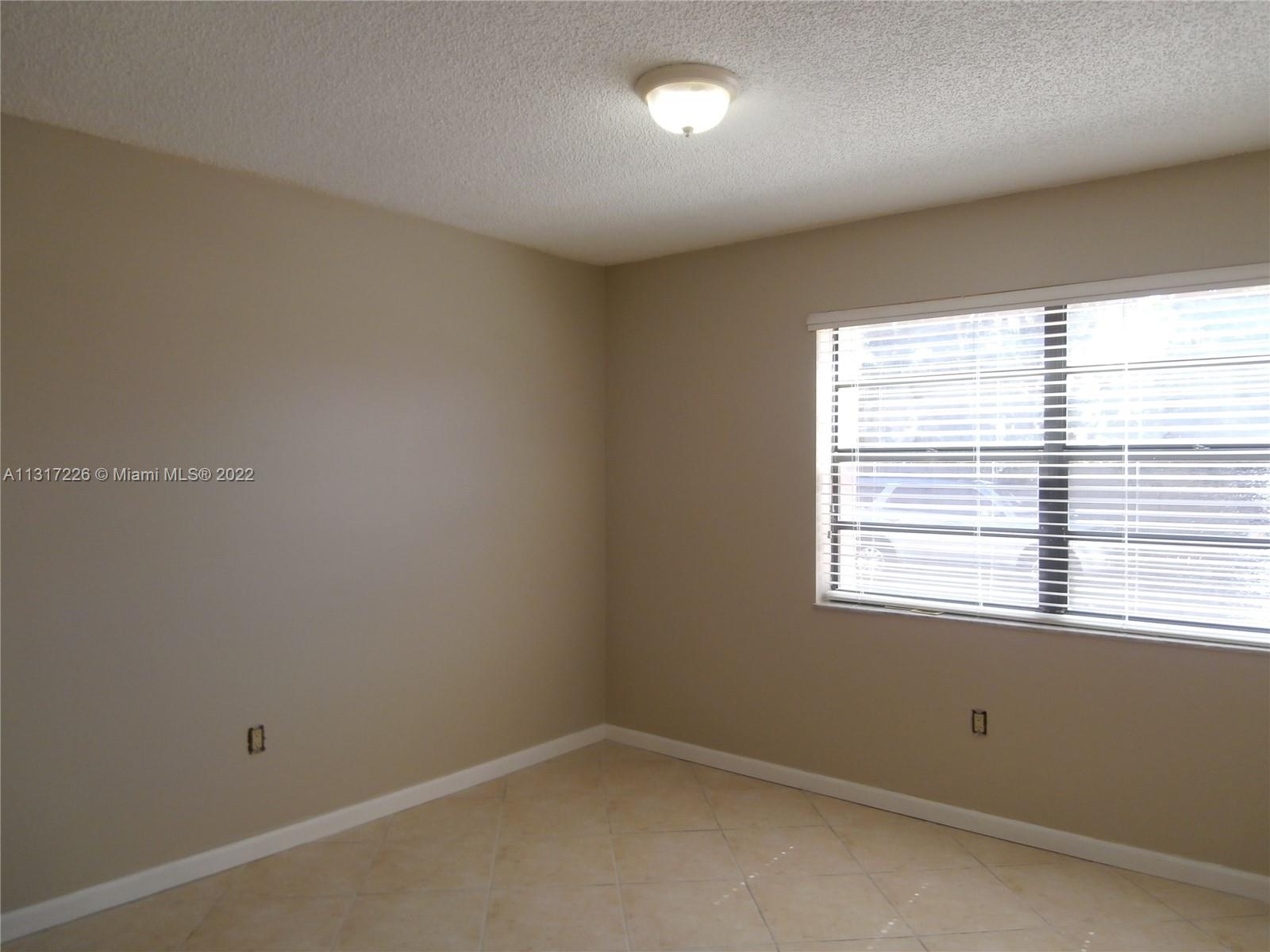Fountainebleau Miami, FL 33174 - Photo 8 of 16 an empty room with a window