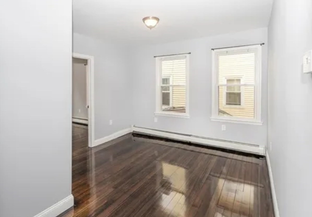 32 Park Street Salem, MA 01970 - Photo 3 of 5 an empty room with wooden floor and windows
