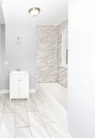 a bathroom with a bathtub and shower