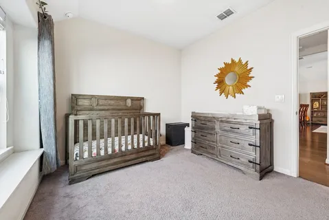 a view of a bedroom with baby crib
