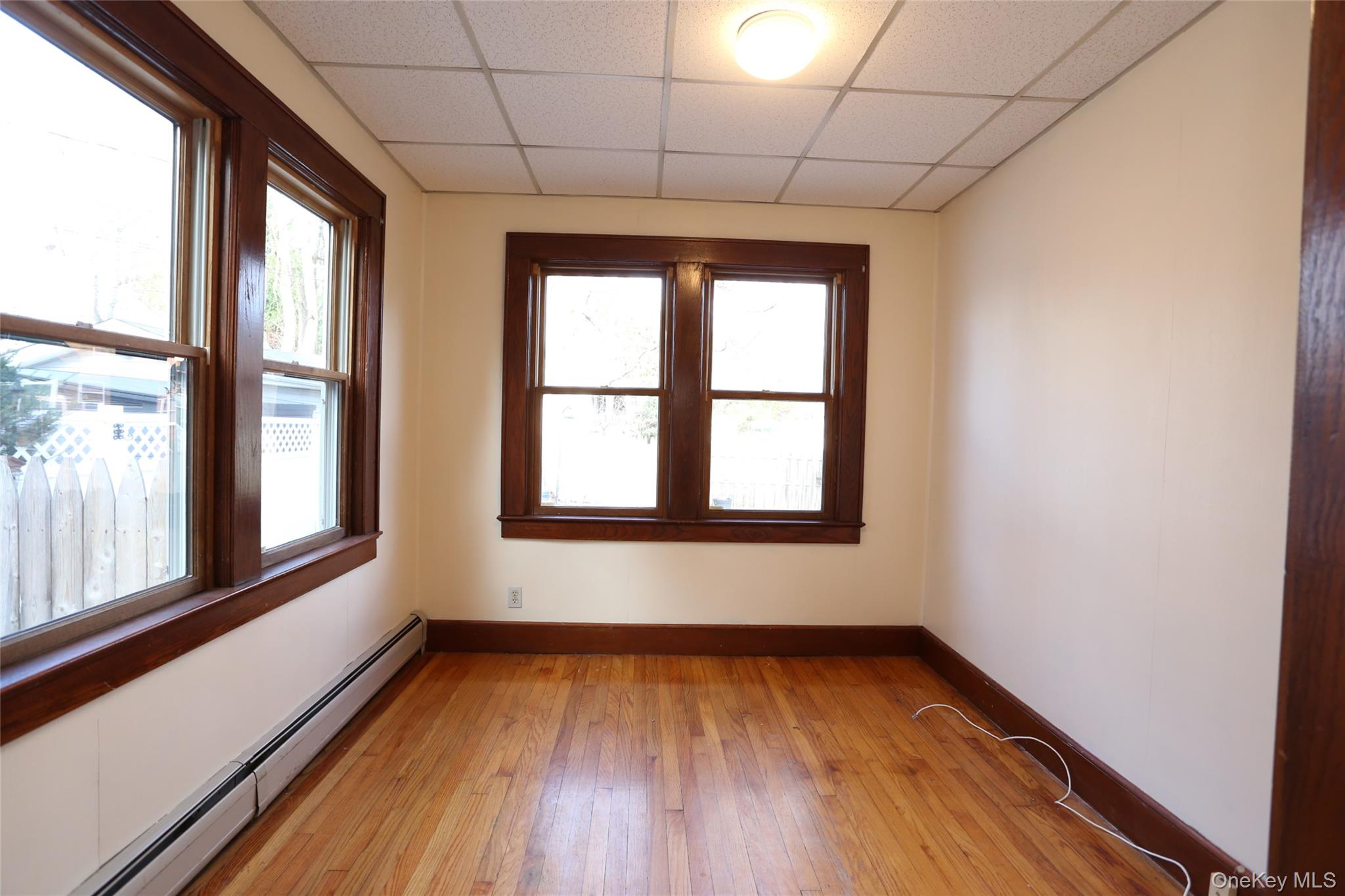 113 Brewery Road New City, NY 10956 - Photo 12 of 39 Spare room featuring a baseboard radiator, a paneled ceiling, and light wood finished floors