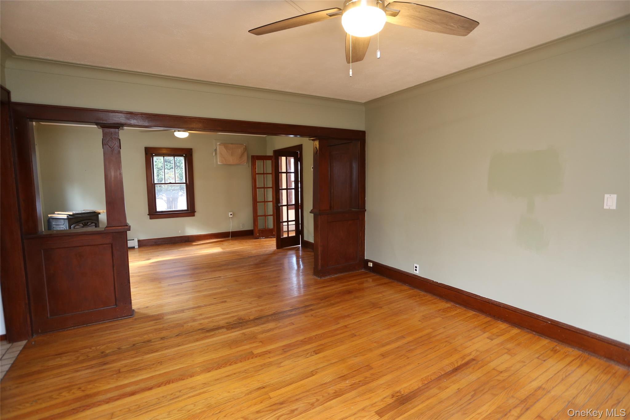 113 Brewery Road New City, NY 10956 - Photo 18 of 39 Unfurnished room featuring light wood-type flooring, ceiling fan, ornamental molding, and french doors