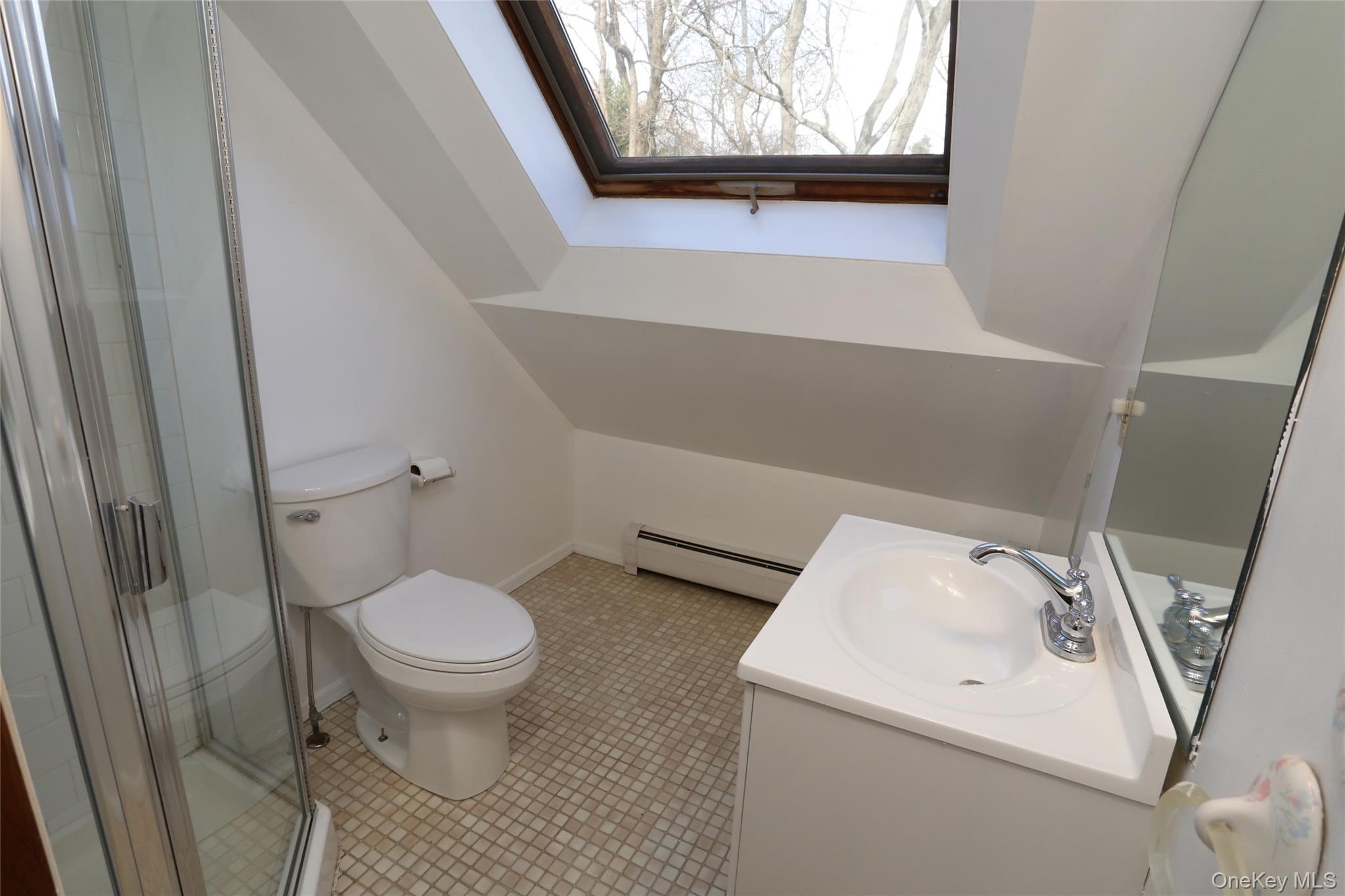 113 Brewery Road New City, NY 10956 - Photo 26 of 39 Bathroom featuring vanity, a baseboard heating unit, a shower stall, and light tile patterned floors