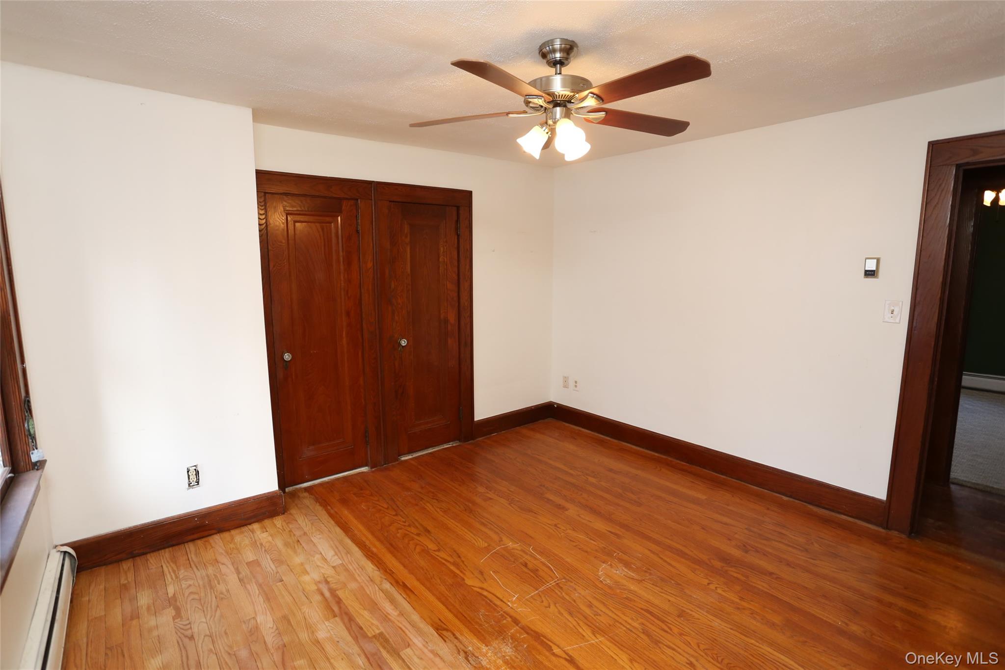 113 Brewery Road New City, NY 10956 - Photo 29 of 39 Unfurnished bedroom featuring light wood-style flooring, a closet, a baseboard radiator, and ceiling fan