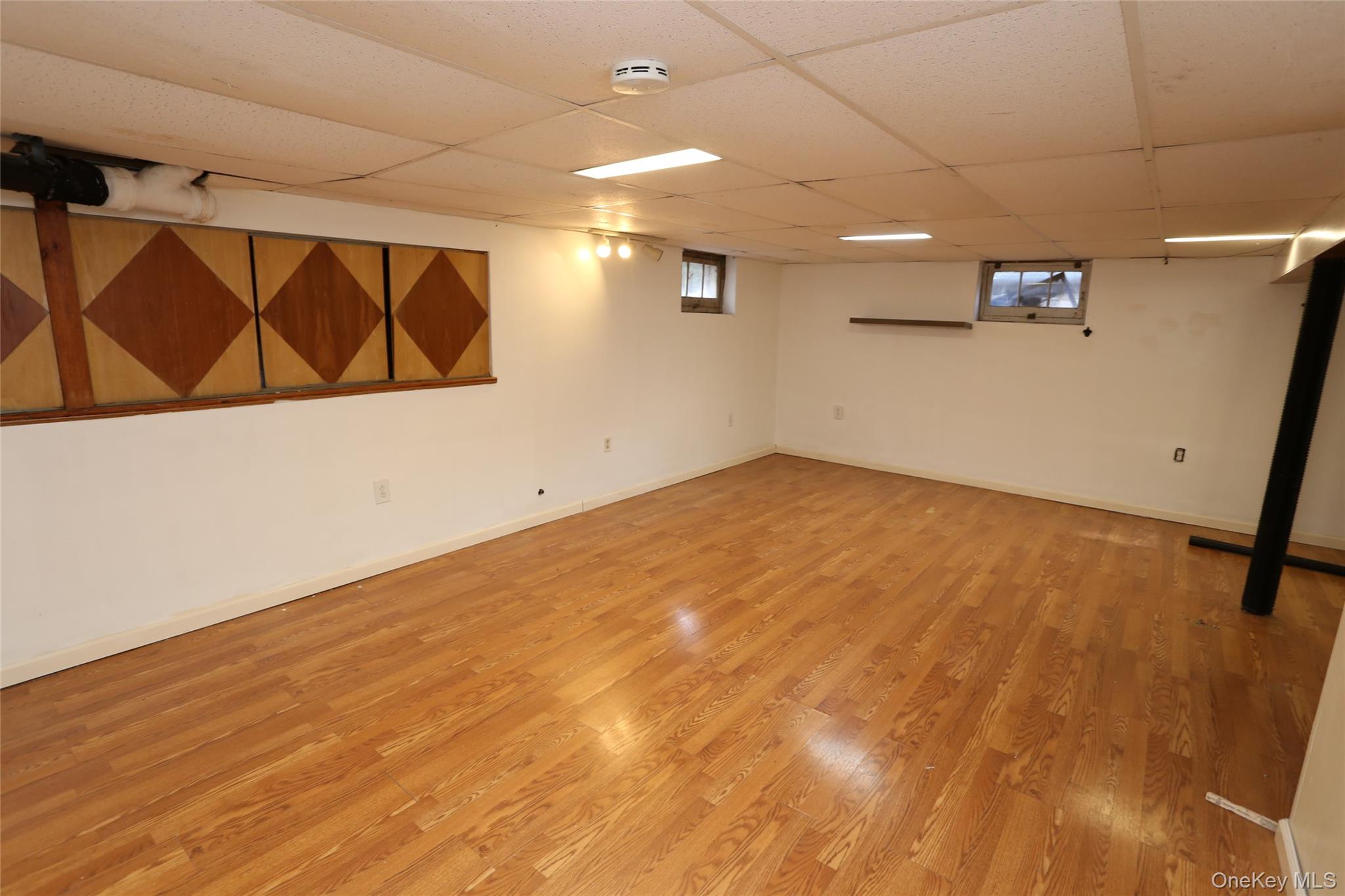 113 Brewery Road New City, NY 10956 - Photo 38 of 39 Below grade area featuring light wood-type flooring and a paneled ceiling